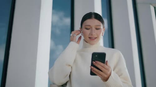 Smiling woman uses phone for video call
