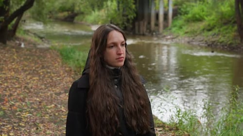 Pensive Lady Along Creek in Fall Solitary Woman with Long Hair Walks By River During Autumn Lone