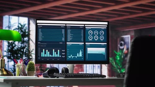 Desktop PC on the Wooden Desk Showcases Infographics and Client Reach Data