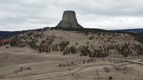 Car Driving by Devils Tower in Wyoming