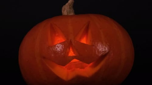 Glowing Carved Pumpkin for Halloween on Black