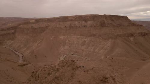 Aerial shot of tourists looking down onto the Makhtesh Ramon Crater In Negev Desert, Israel.