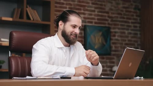 Smiling Businessman Having Online Meeting in Cozy Office