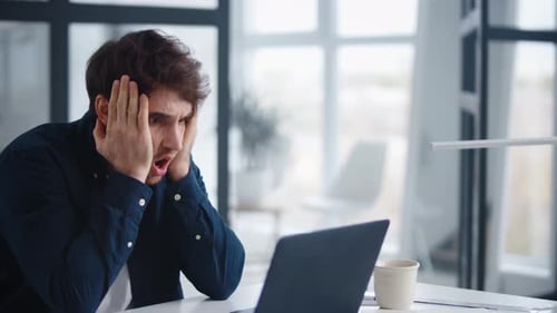 Sad Businessman Closing Face in Front of Computer in . Close