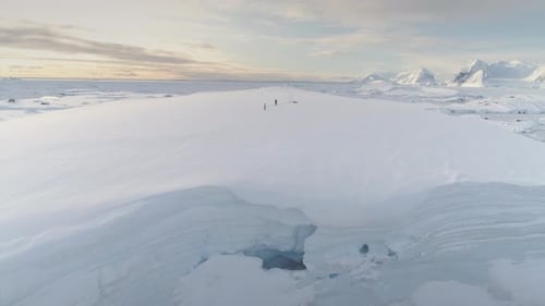 Blue Ice Cave in White Glacier on Antarctic Peninsula Aerial Shot Closeup