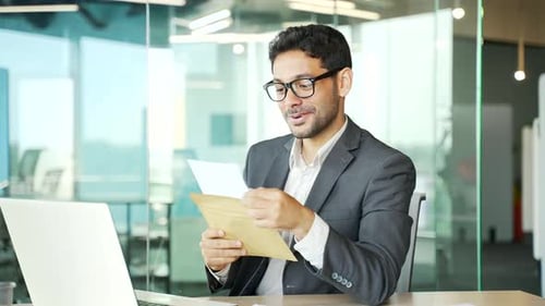 Young Man Reacts to Good News in Letter