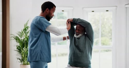Healthcare Professional Helping Senior Man With Arm Stretches