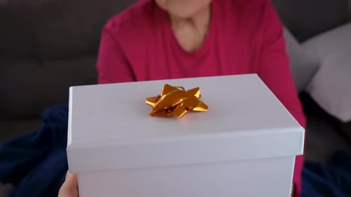 Woman Receives a Birthday Gift on Couch
