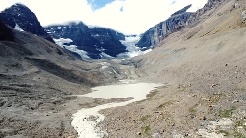 Columbia icefield glacier melting into glacial lake in canadian rockies