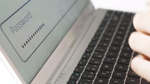 Close Up of Fingers Typing Password on Laptop