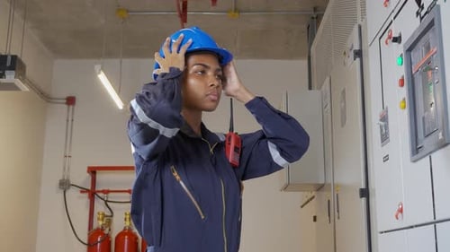 Electrician Puts on Hard Hat and Inspects Panel