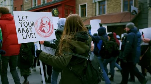 People Marching with Signs in City Protest
