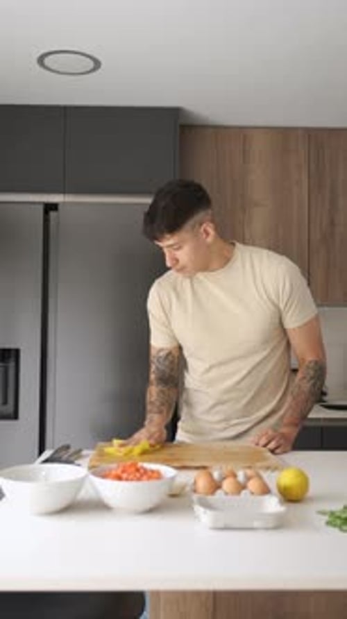 Young Latin Man Cleaning Chopping Board and Kitchen Counter
