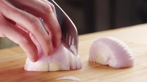 Chef Chopping a Red Onion with a Knife on the Cutting Board Macro Close Up of Cutting Red Onion on