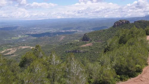 Aerial view of sensational scene in Montserrat mountain range, drone flying above pine tree reveal b