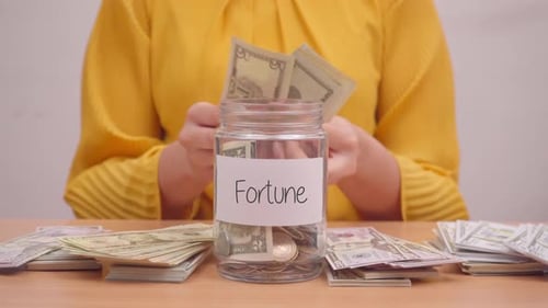Fortune Money, Woman Putting Money in Jar