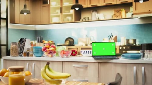 Green Screen on Laptop in the Kitchen with Rustic Counter and Elegant Lighting