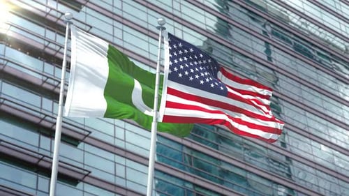 Pakistan and USA Flags Waving in Front of Modern Corporate Building
