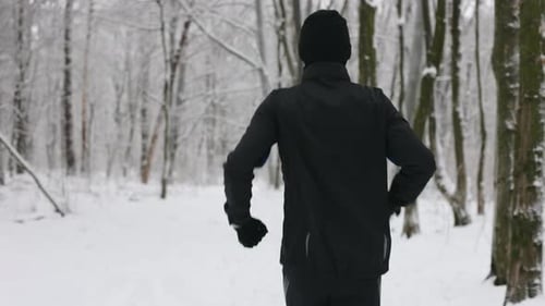 Back View of Man Having Cardio Exercise at Winter Forest