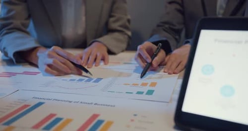 Business People Reviewing Financial Charts and Data