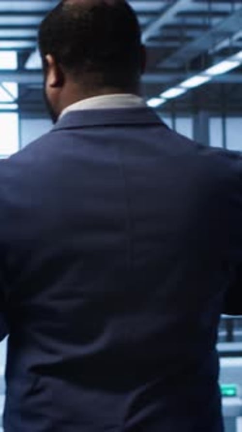 Man in Blazer Uses Tablet in Office