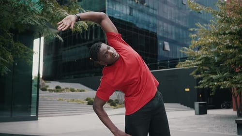 Successful Man Engaging in Stretching Exercises on Street