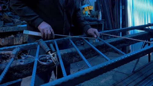 Welder is Measuring and Welding