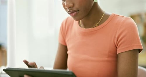 Woman Using Tablet in Bright Indoor Setting