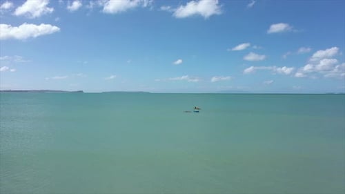 Teams Of Lifeguards In The Bright Blue Sea During Rescue Safety Training In Summer - aerial drone