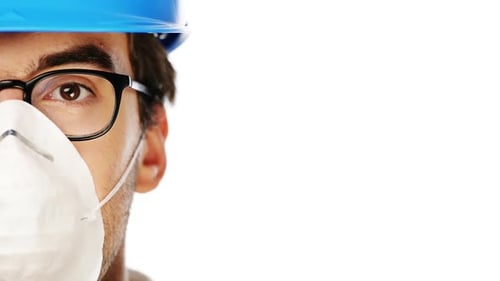 4k video footage of a young man wearing a mask and hard hat against a white studio background