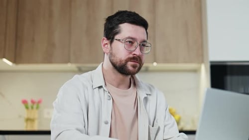 Young Adult Using Laptop at Home