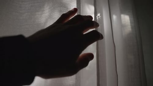 Hand Opens Curtain Revealing Sunny Day