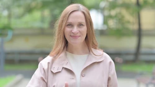 Woman Giving a Thumbs Up Outside