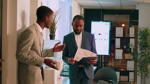 Business Manager Checking Up on Employee