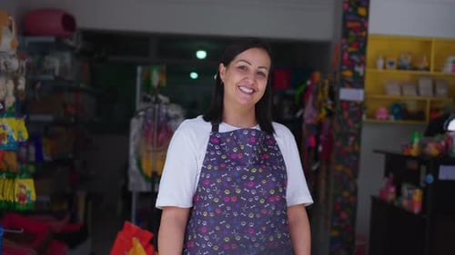 Portrait of a happy female entrepreneur posing for camera in front of Pet Shop, small business