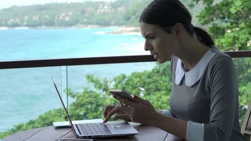 Young Businesswoman Working with Smartphone and Laptop Sitting on Terrace Adult