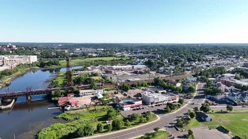 An aerial view by the Norwalk River Railroad Bridge on a sunny morning. The drone camera dolly in an