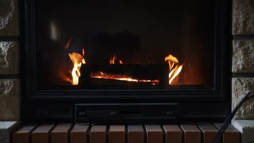 Warmth emanating from a burning fireplace creates a cozy winter home atmosphere