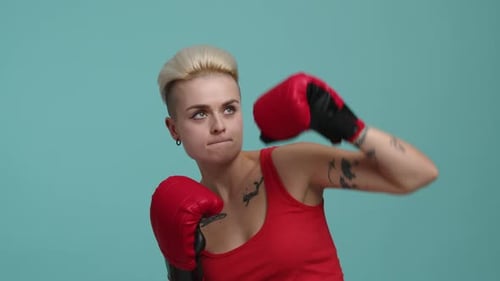 Closeup View of Fighting Woman with Short Hair Wearing Red Boxing Gloves