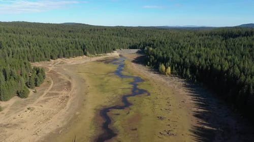 Aerial drone flying above a lake with no water that was affected by drought.