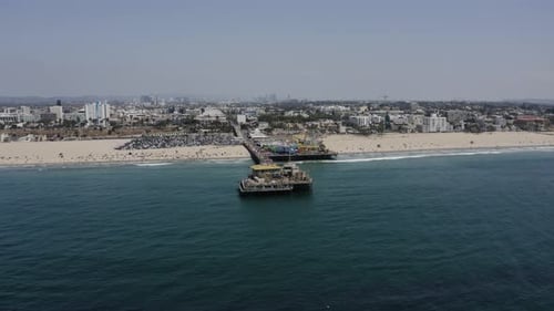 Aerial view of Santa Monica Pier famous landmark on California coast. Cityscape of Los Angeles on ho