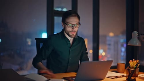 Professional Consultant Answering Call at Night Office Writing Notes Closeup