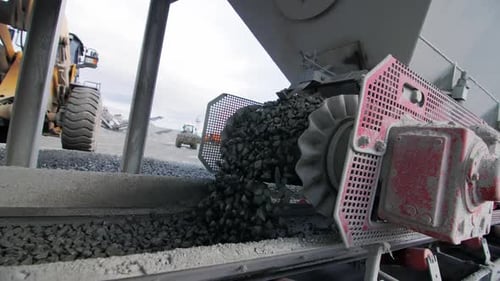 Pouring Granite From Funnel on Conveyor Belt at Mining Pit