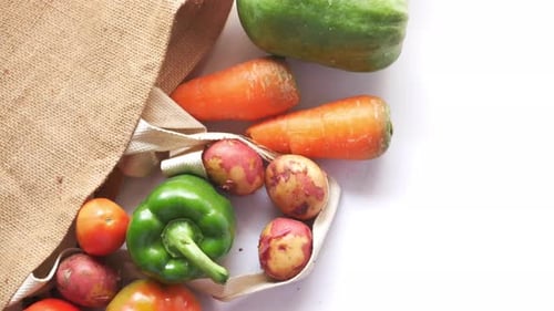 Recycled Arrows Sign on a Shopping Bag with Vegetable