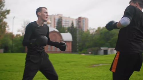 Amateur Boxing Training in Park Two Men Sparring with Pads Outside Caucasian Men Engage in Intense