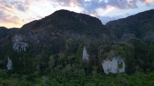 evening sunset over mountain peaks. Gorgeous aerial top view flight descending drone
4k