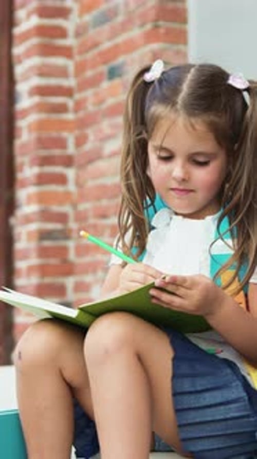 Two School Little Children Pupils Girl and Boy Classmates Friends Sitting on Stairs Street Outdoors