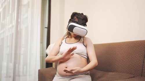 Pregnant Woman Uses Virtual Reality Headset at Home