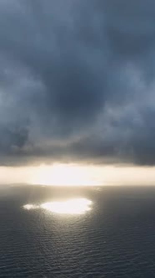 Vertical Video Cloudy Magic Aerial View of Dramatic Sunset Over Sea and City