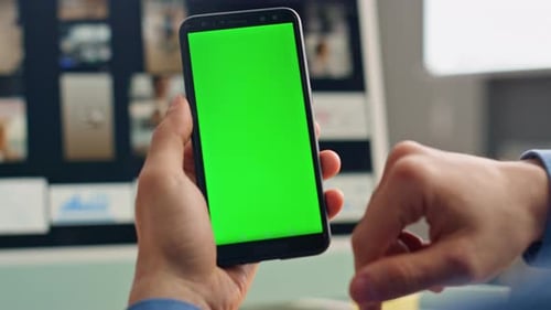 Man Holding Phone With Green Screen Display